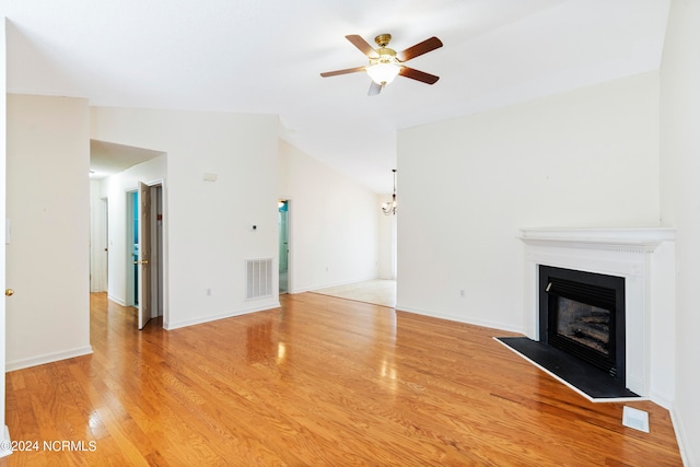 unfurnished living room featuring light hardwood / wood-style flooring, vaulted ceiling, and ceiling fan