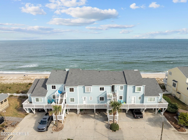 drone / aerial view featuring a view of the beach and a water view