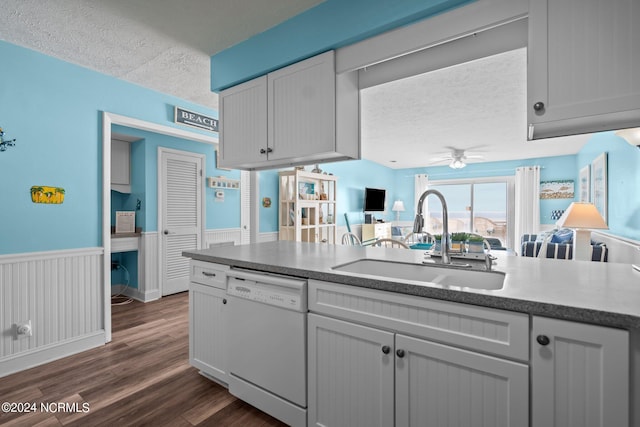 kitchen with ceiling fan, dark hardwood / wood-style flooring, sink, white dishwasher, and a textured ceiling