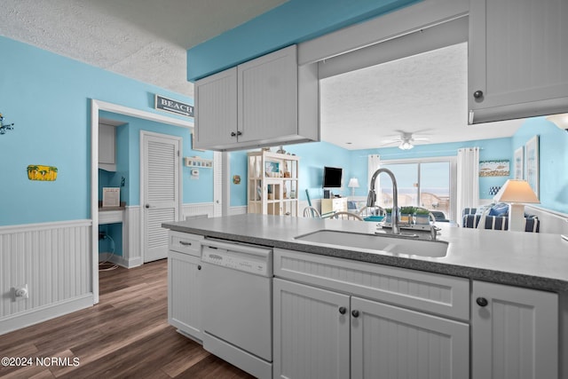 503 Pelican Ct Unit 503, Kure Beach, NC 28449 - kitchen with white dishwasher, a sink, a textured ceiling, wainscoting, and ceiling fan