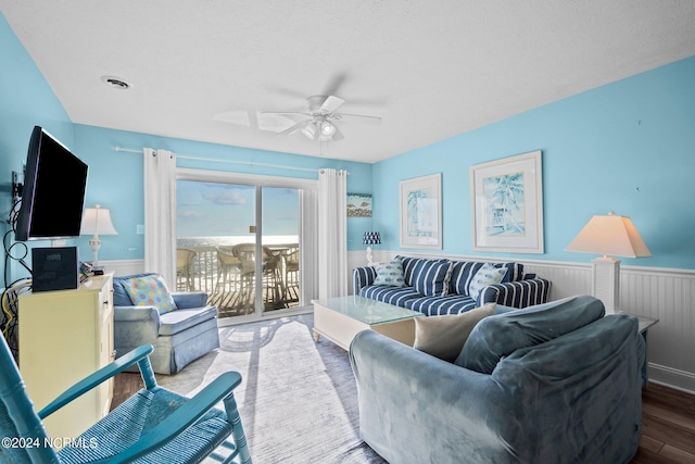 503 Pelican Ct Unit 503, Kure Beach, NC 28449 - living area with ceiling fan, a wainscoted wall, wood finished floors, and visible vents