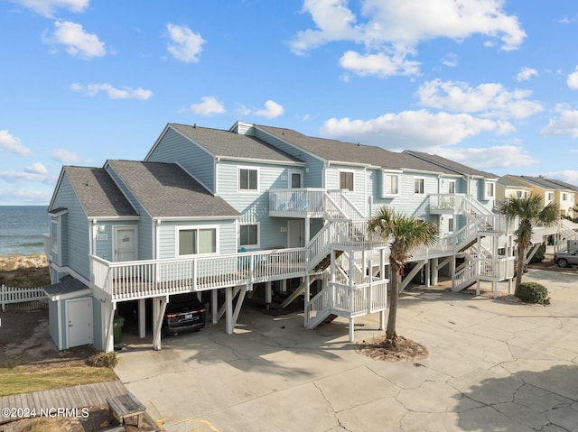 back of property featuring a water view and a carport