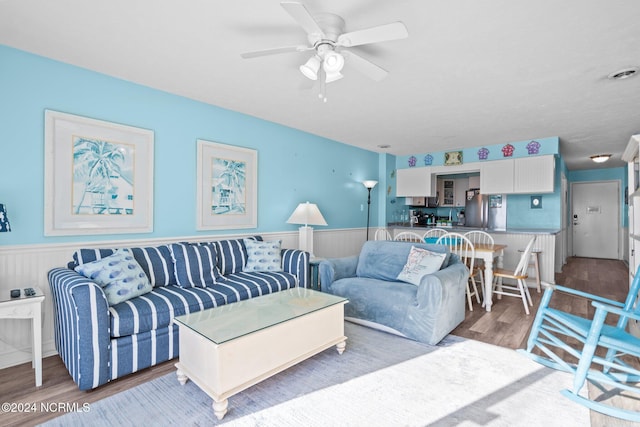 503 Pelican Ct Unit 503, Kure Beach, NC 28449 - living room with wood finished floors, a wainscoted wall, and ceiling fan