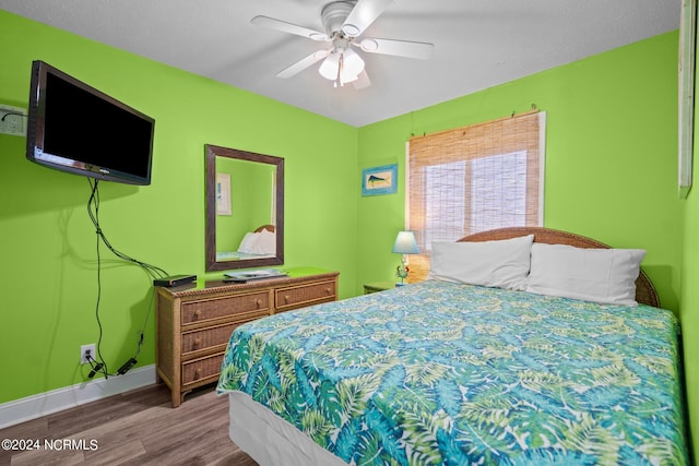 bedroom with ceiling fan and hardwood / wood-style floors