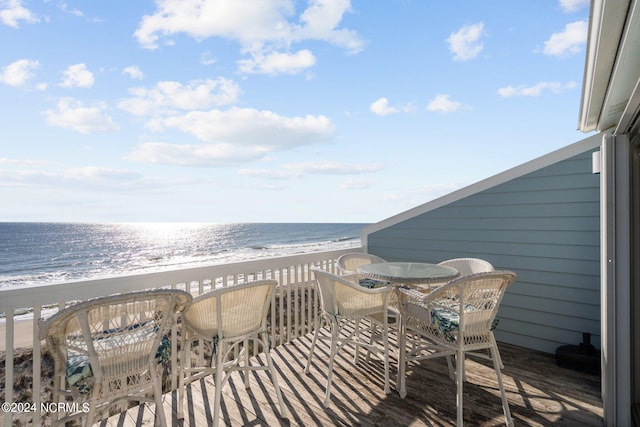 balcony featuring a water view and a beach view