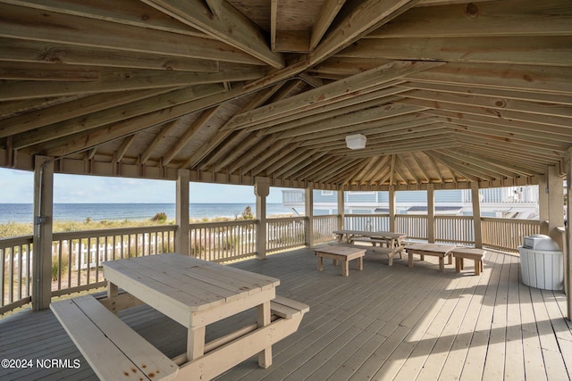 deck featuring a beach view, a gazebo, and a water view