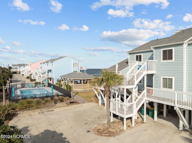503 Pelican Ct Unit 503, Kure Beach, NC 28449 - view of property with a fenced in pool and stairs