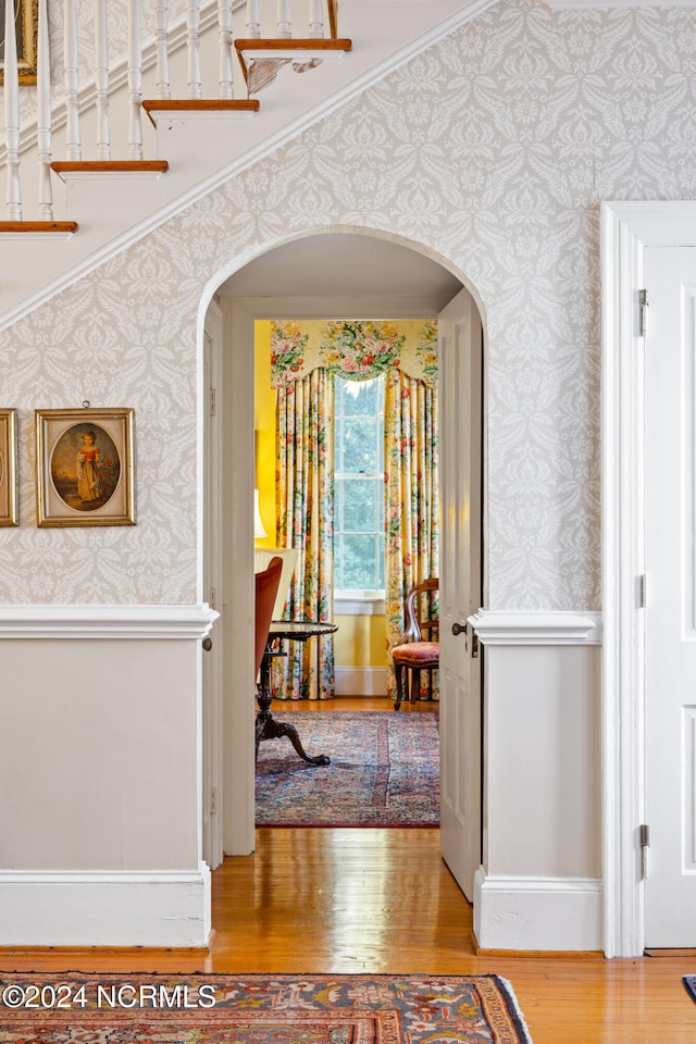 hall with crown molding and hardwood / wood-style floors