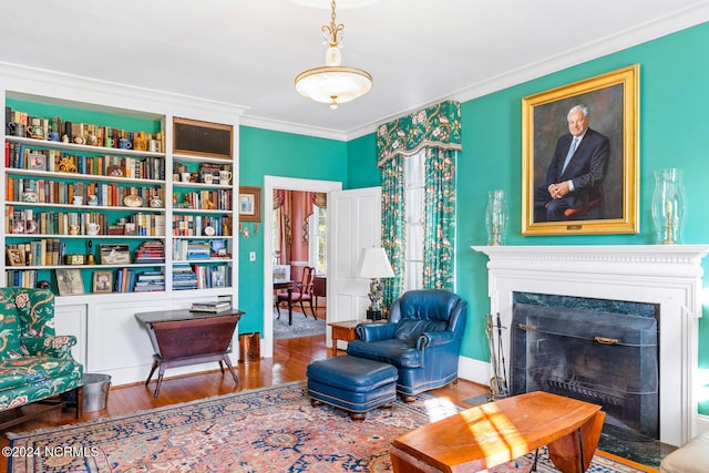 living area featuring ornamental molding and hardwood / wood-style floors