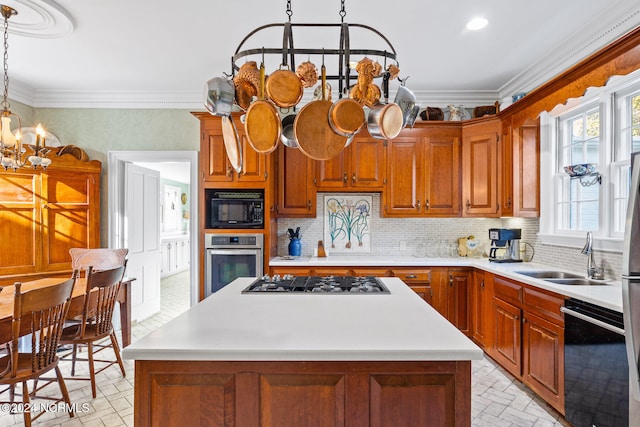 kitchen with ornamental molding, decorative light fixtures, black appliances, and sink