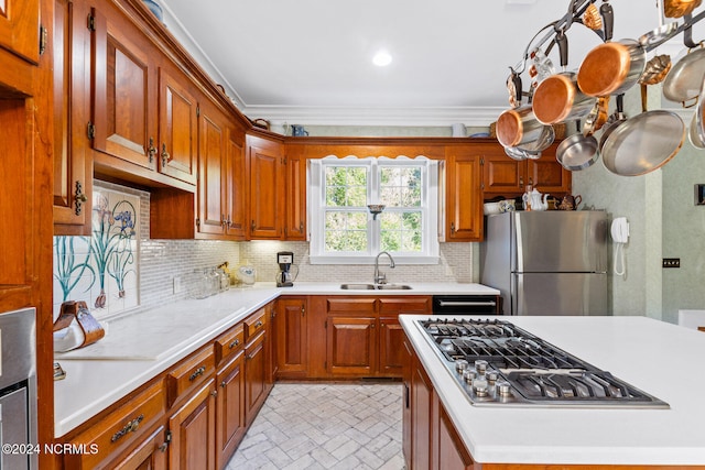 kitchen featuring backsplash, crown molding, appliances with stainless steel finishes, and sink