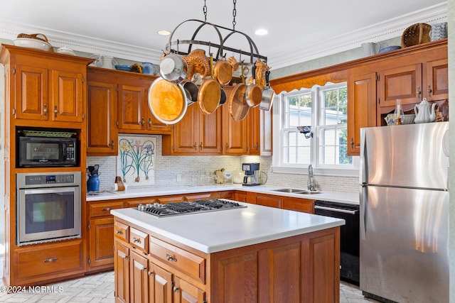 kitchen featuring hanging light fixtures, a kitchen island, black appliances, crown molding, and sink