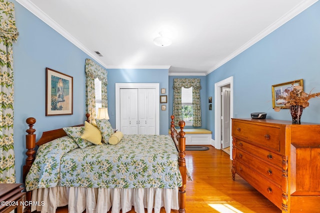 bedroom with a closet, crown molding, and light wood-type flooring