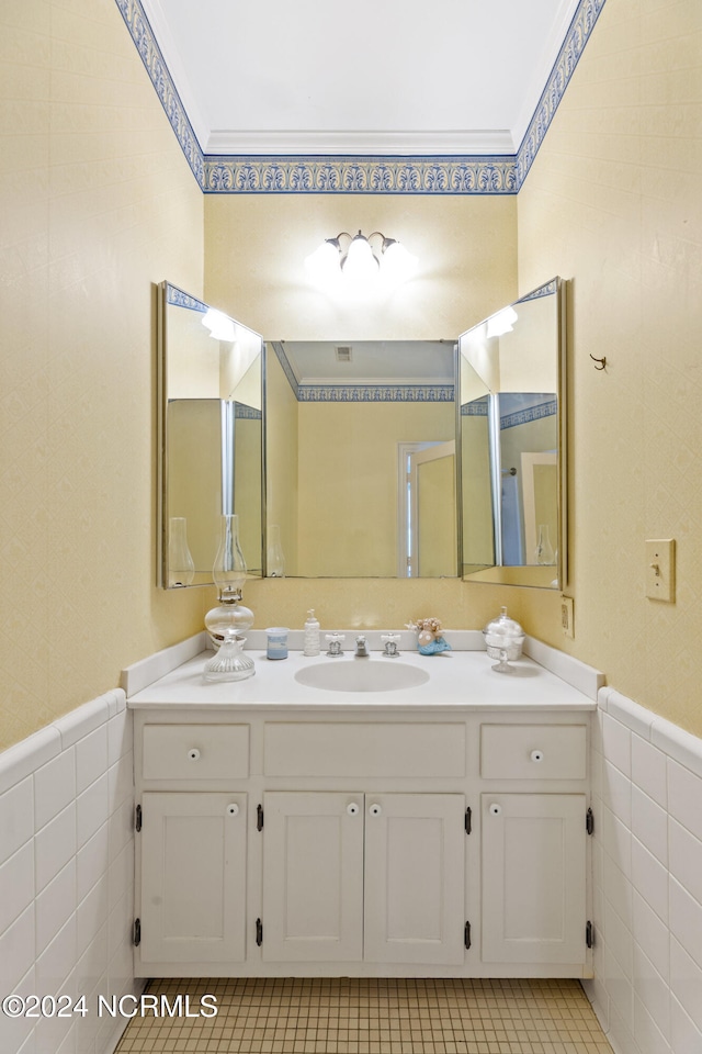 bathroom with vanity, crown molding, tile patterned floors, and tile walls