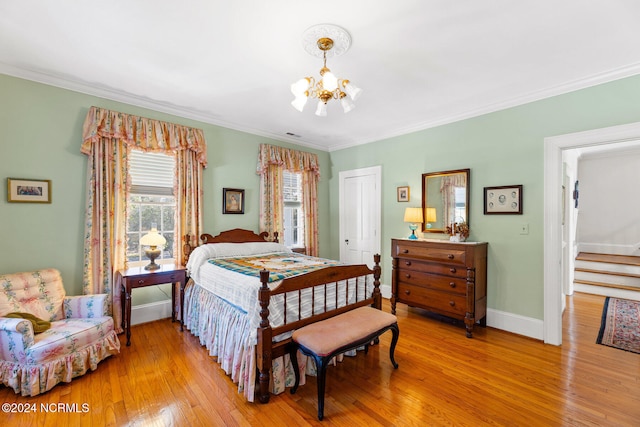 bedroom with crown molding, an inviting chandelier, and light wood-type flooring