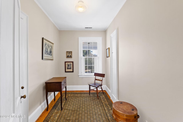 hall featuring ornamental molding and hardwood / wood-style flooring