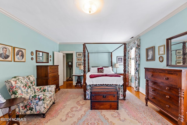 bedroom with ornamental molding and light wood-type flooring