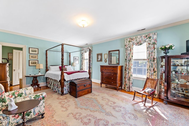 bedroom with light hardwood / wood-style floors and ornamental molding