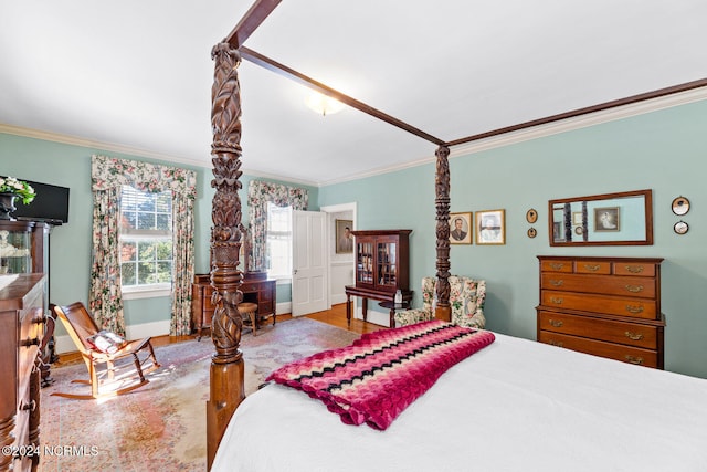 bedroom with ornamental molding and wood-type flooring