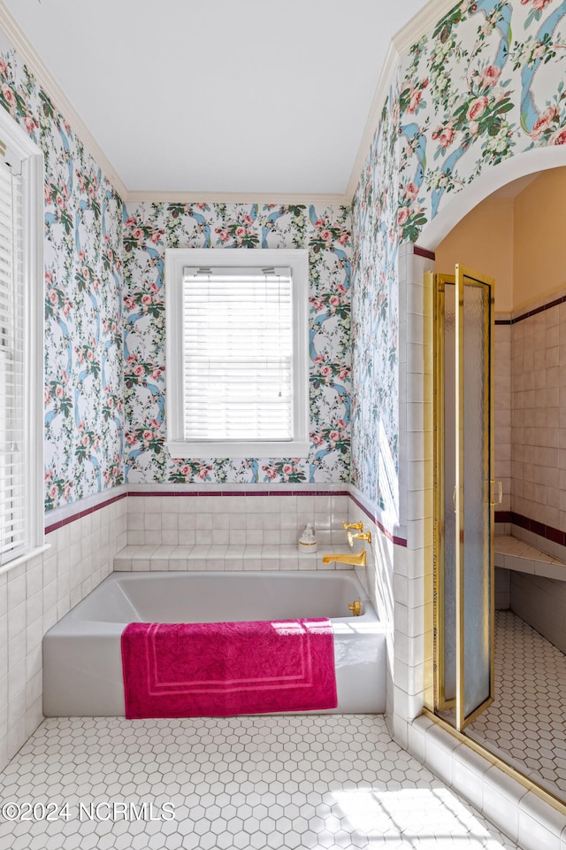 bathroom with ornamental molding and separate shower and tub