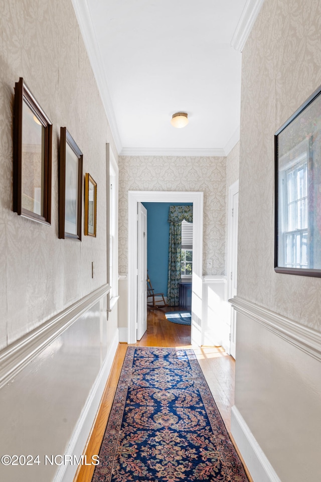 corridor with crown molding and light wood-type flooring