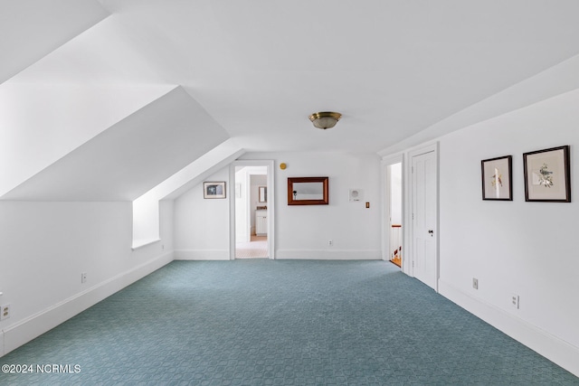 bonus room featuring carpet floors and vaulted ceiling