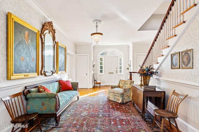 living area featuring hardwood / wood-style floors and crown molding