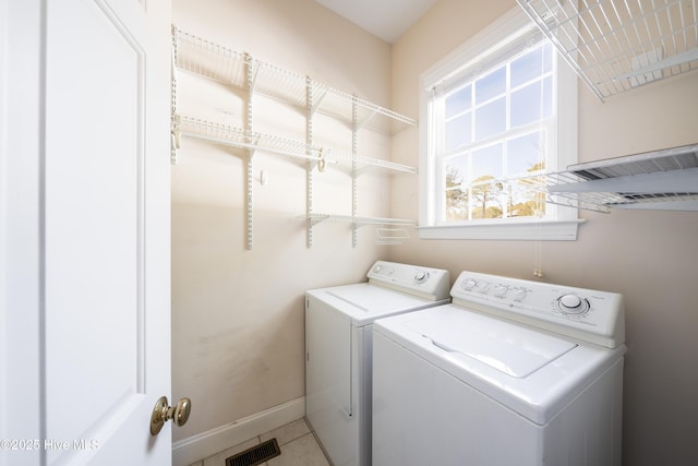 washroom featuring separate washer and dryer and tile patterned flooring