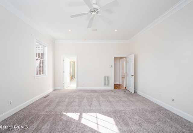 unfurnished room with crown molding, light colored carpet, and ceiling fan