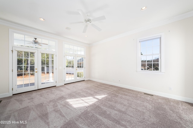 carpeted spare room featuring french doors, ceiling fan, and crown molding