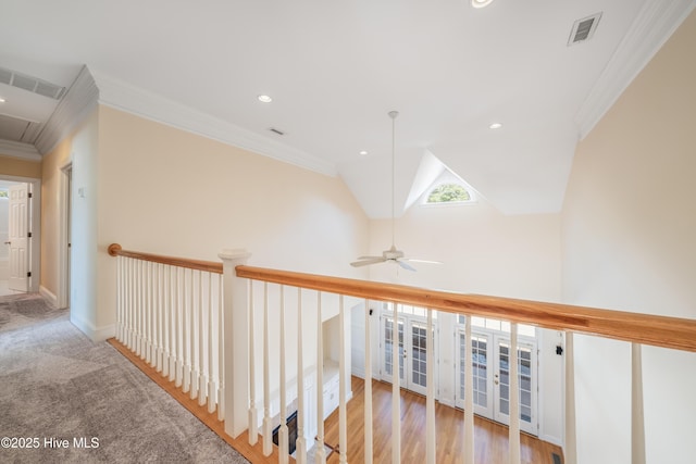 hallway featuring ornamental molding and lofted ceiling