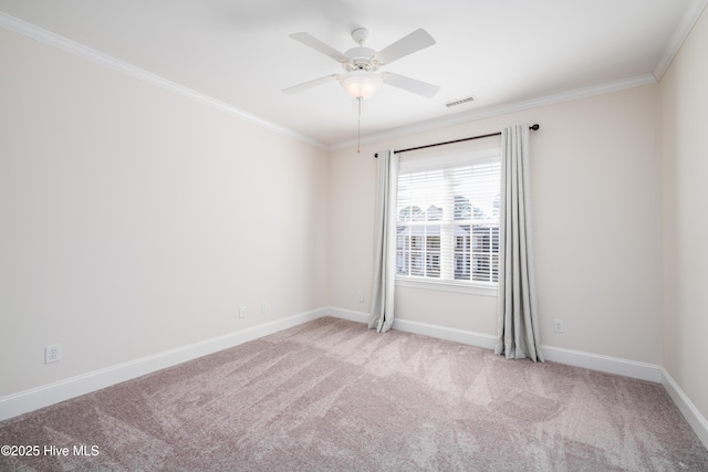 spare room with ornamental molding, light colored carpet, and ceiling fan