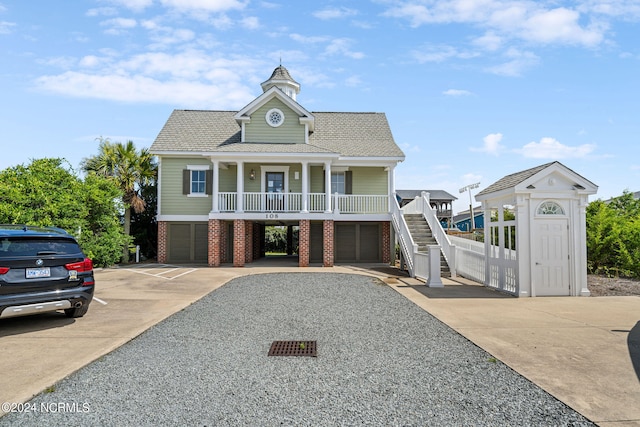 view of front of house with a garage and a porch