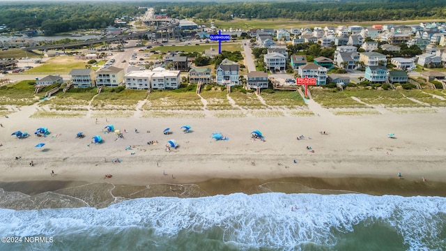 drone / aerial view featuring a water view and a view of the beach