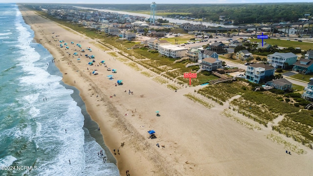 birds eye view of property featuring a water view and a beach view