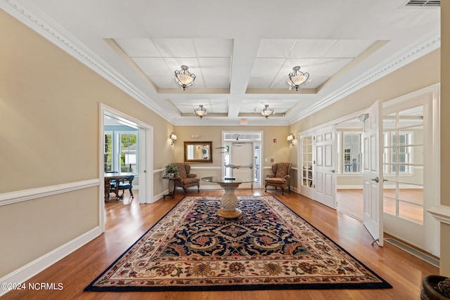 interior space with french doors, hardwood / wood-style floors, coffered ceiling, beamed ceiling, and ornamental molding