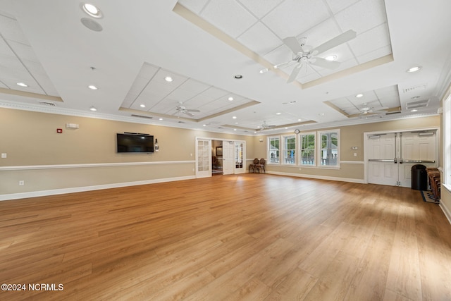 unfurnished living room with light hardwood / wood-style flooring, ceiling fan, a tray ceiling, and crown molding