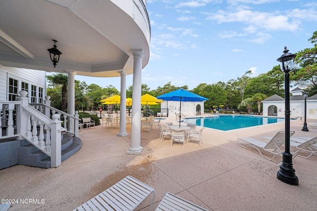 view of pool with a patio and an outdoor structure