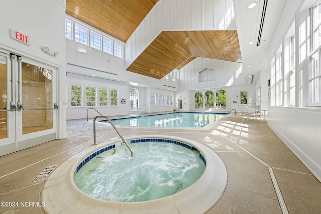 view of swimming pool featuring an indoor hot tub