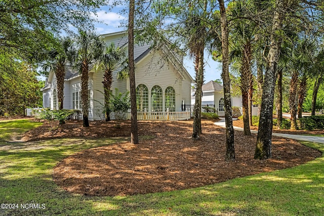 view of property exterior with a yard