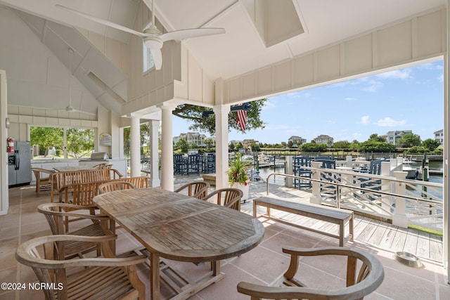 view of patio / terrace featuring a water view and ceiling fan