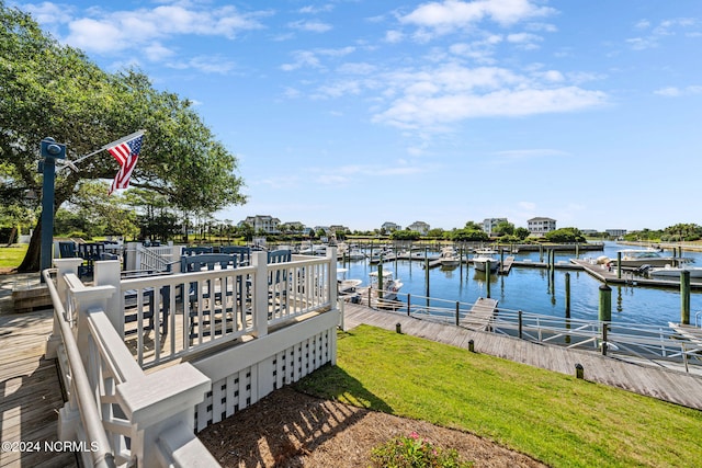 dock area featuring a water view and a lawn