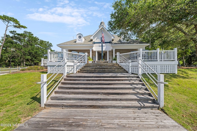 view of front of property with a front yard and a wooden deck