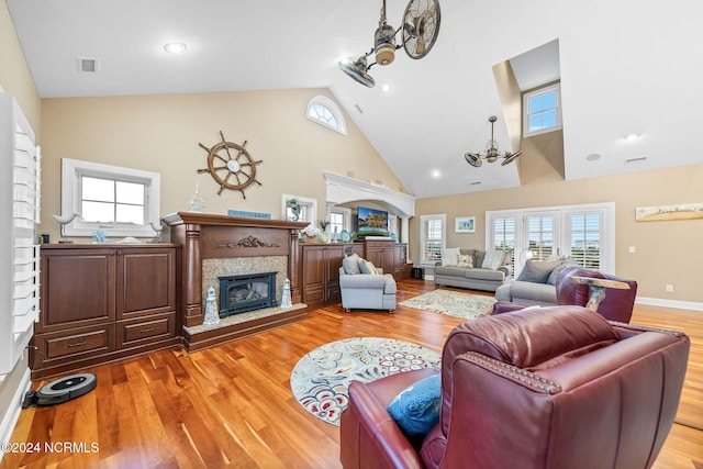 living room featuring high vaulted ceiling, hardwood / wood-style flooring, and a wealth of natural light