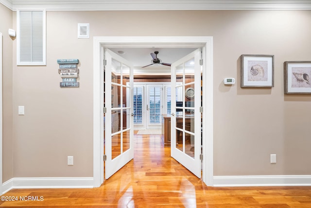 hallway featuring hardwood / wood-style floors, french doors, and crown molding