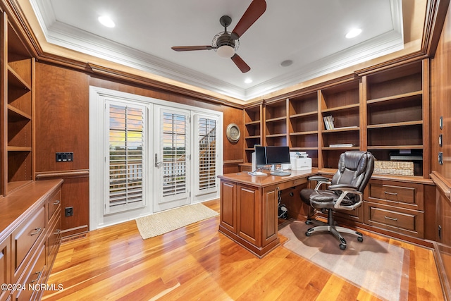 office with ornamental molding, a tray ceiling, light wood-type flooring, and ceiling fan