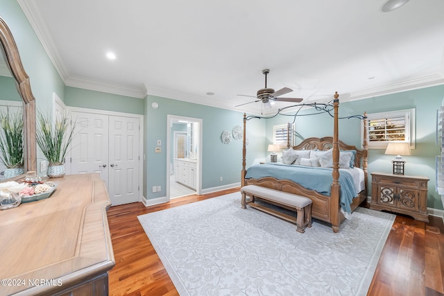 bedroom featuring ceiling fan, hardwood / wood-style flooring, crown molding, ensuite bathroom, and a closet