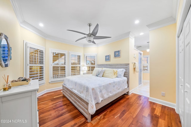 bedroom with ornamental molding, a closet, hardwood / wood-style floors, and ceiling fan