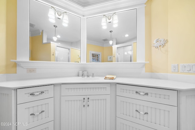 bathroom with vanity, crown molding, and walk in shower