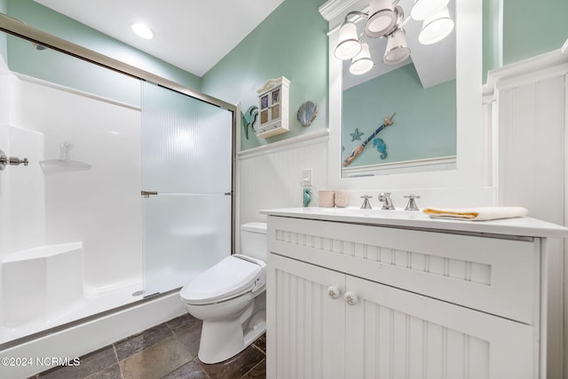 bathroom with vanity, toilet, and an enclosed shower